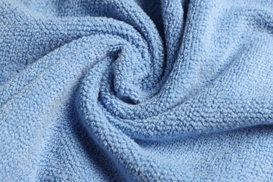 Photo of Soft crumpled blue towel as background, top view