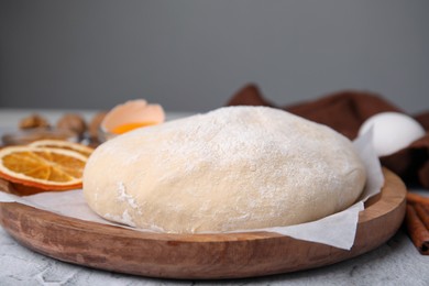 Photo of Fresh dough and ingredients on white table, closeup