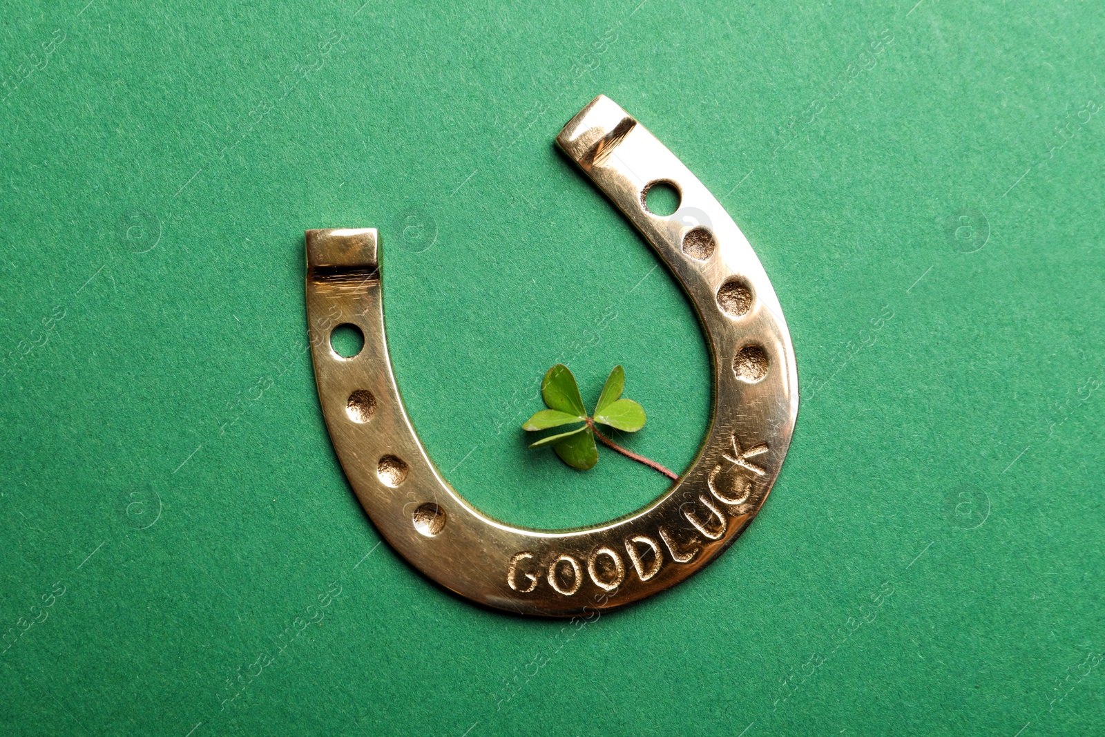 Photo of Flat lay composition with horseshoe on green background. St. Patrick's Day celebration