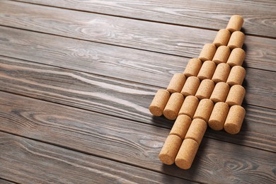 Christmas tree made of wine corks on wooden table. Space for text