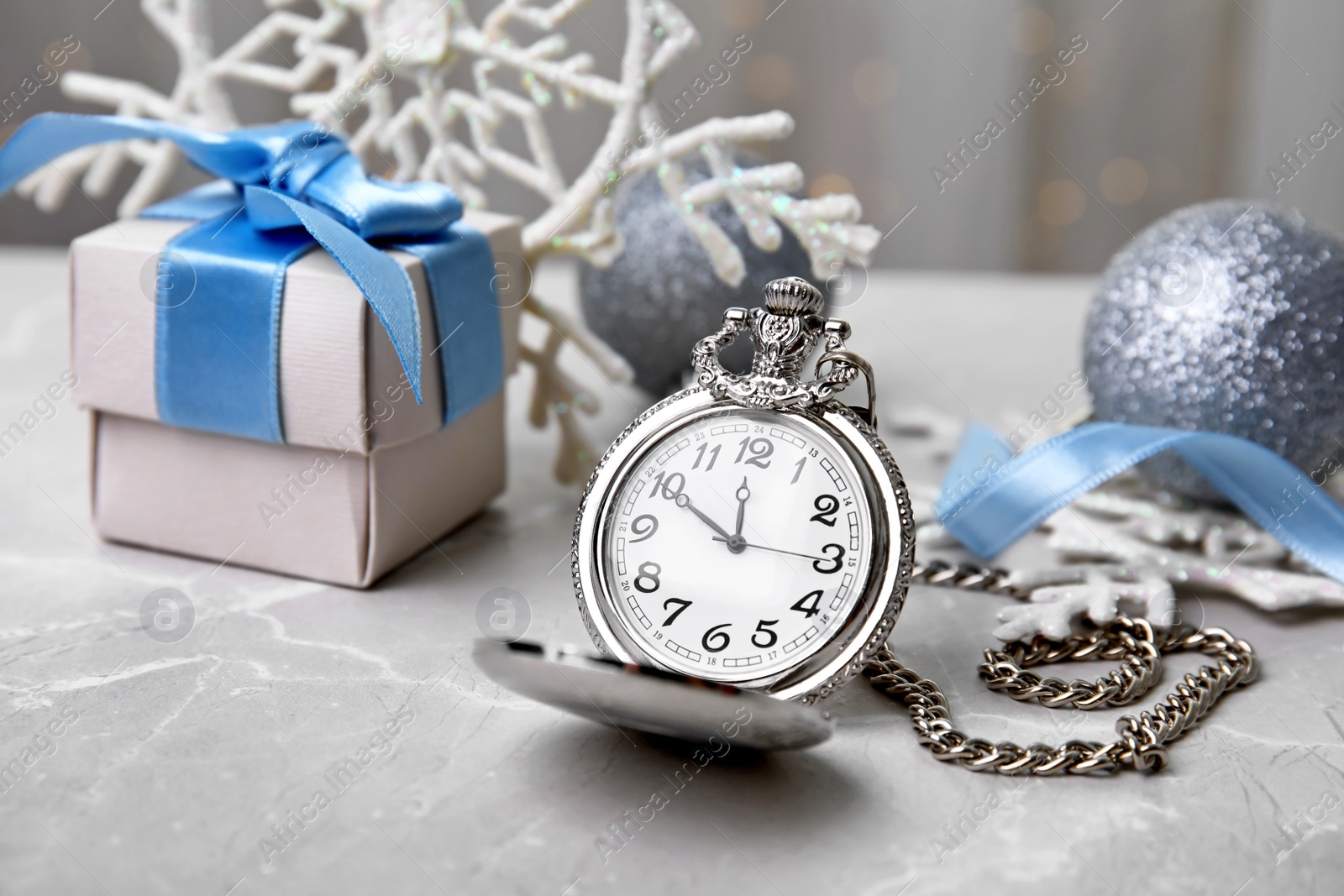 Photo of Pocket watch, gift and festive decor on table. Christmas countdown