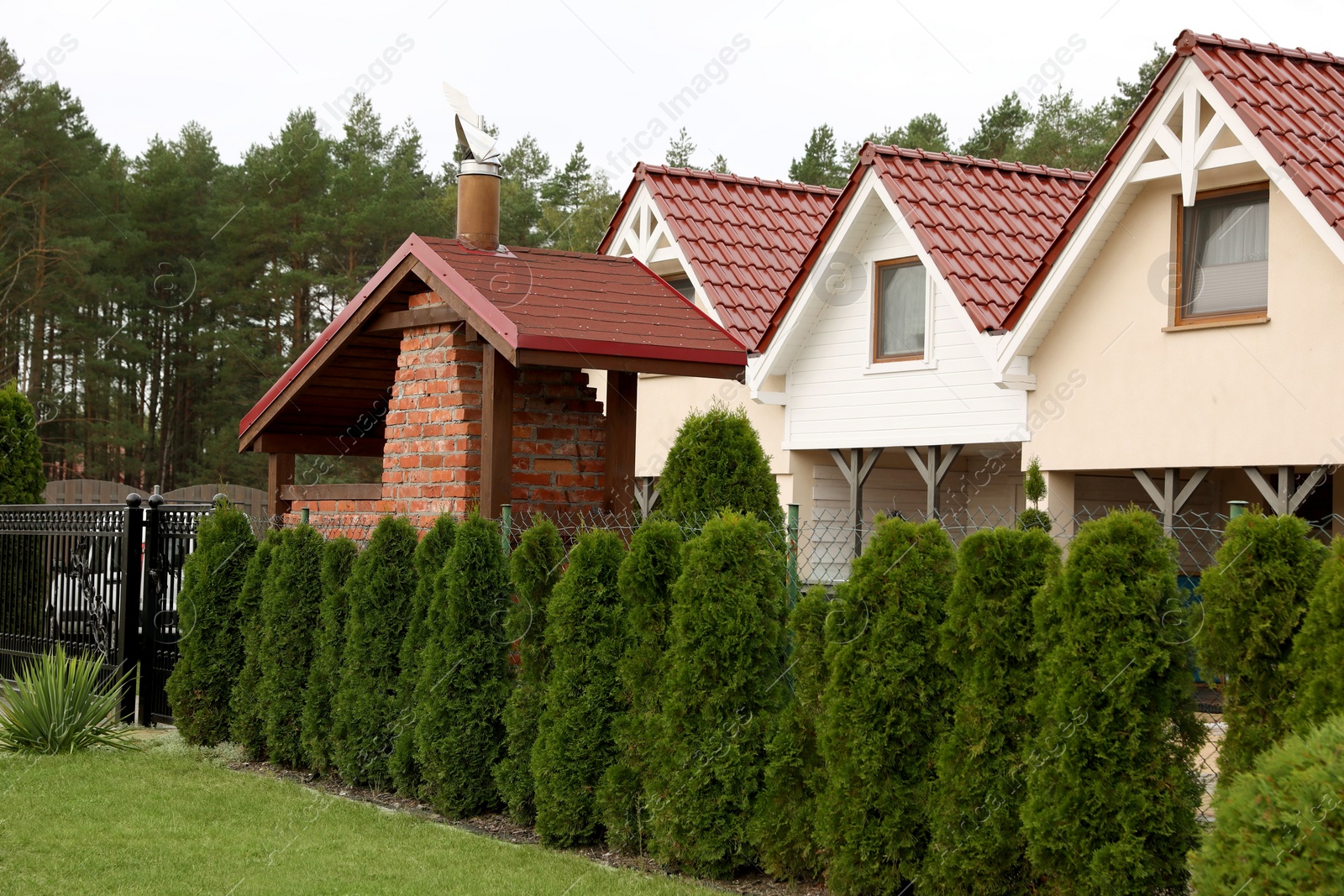 Photo of Beautiful two storey beach house and green trees outdoors