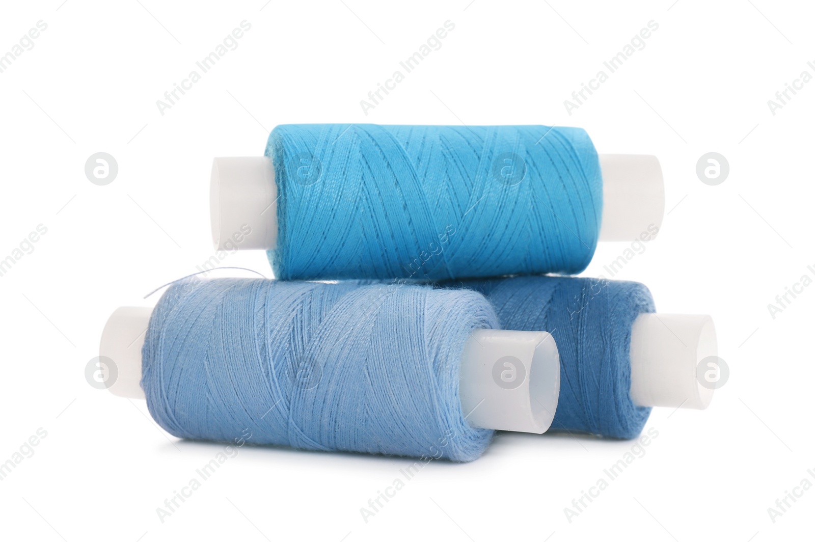 Photo of Different colorful sewing threads on white background