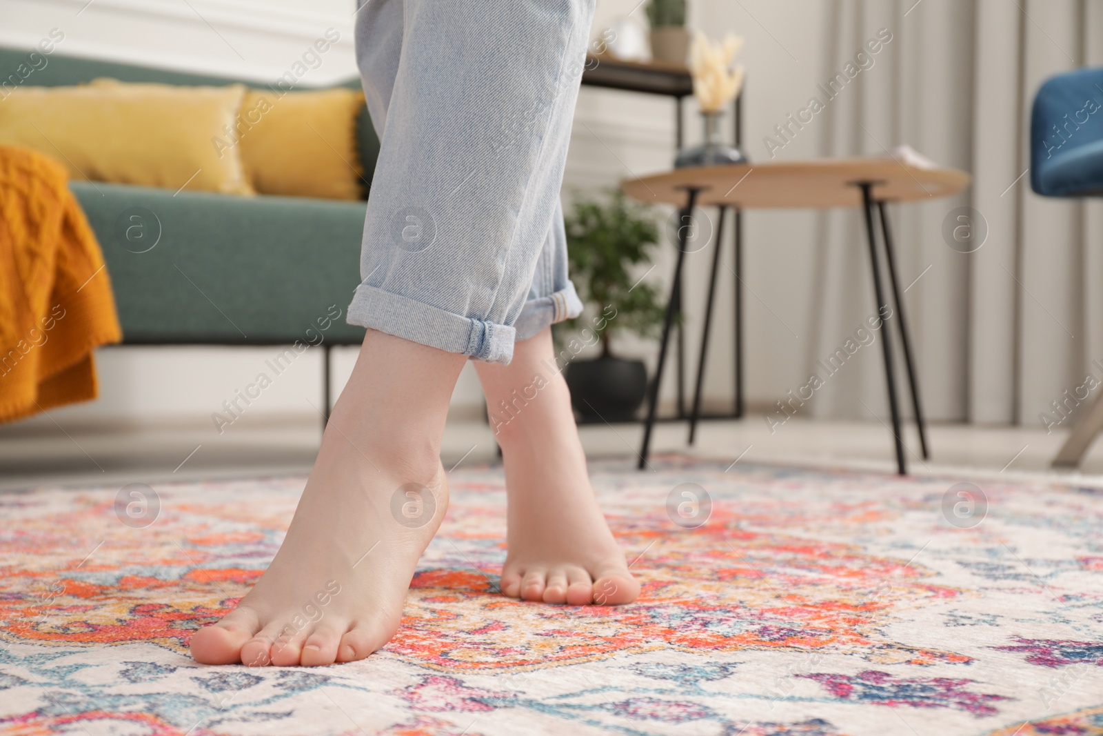 Photo of Woman standing on carpet with pattern in room, closeup. Space for text