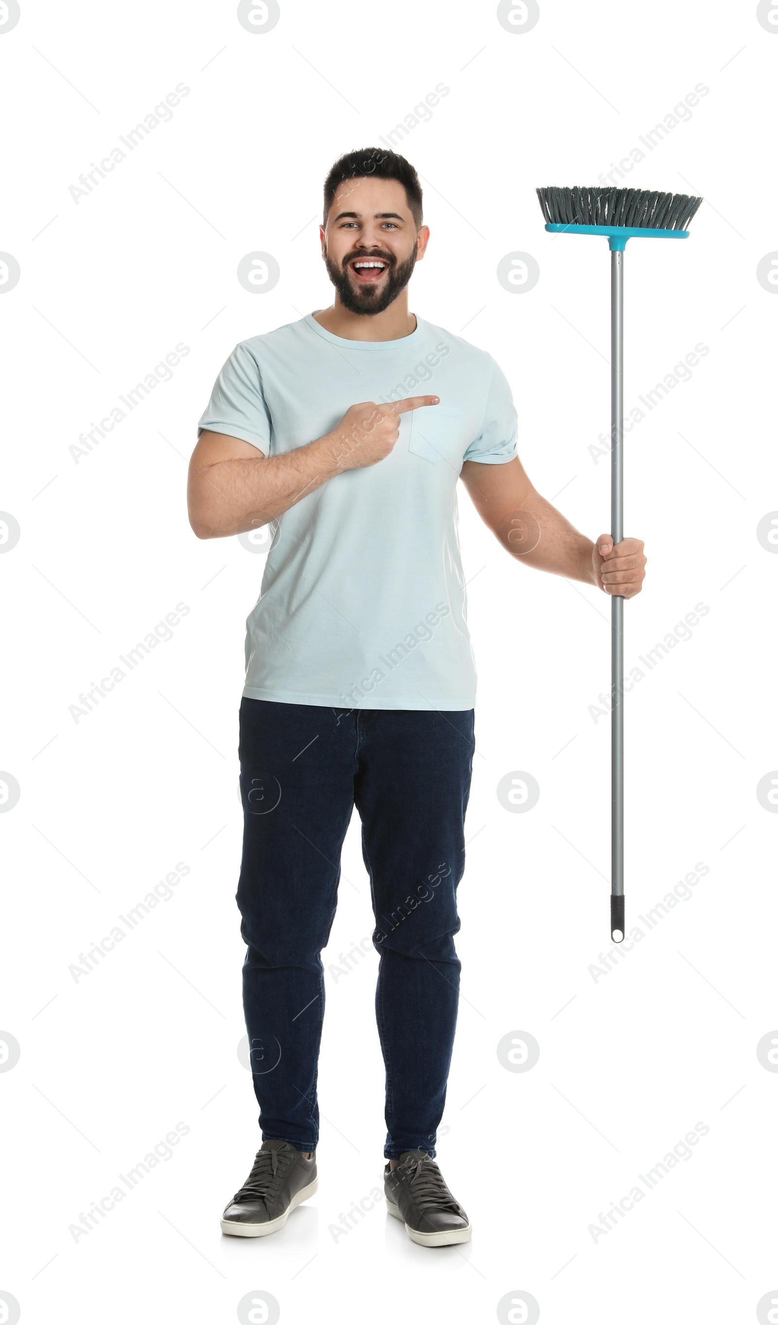 Photo of Young man with broom on white background