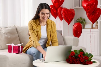 Photo of Valentine's day celebration in long distance relationship. Woman chatting with her boyfriend at home