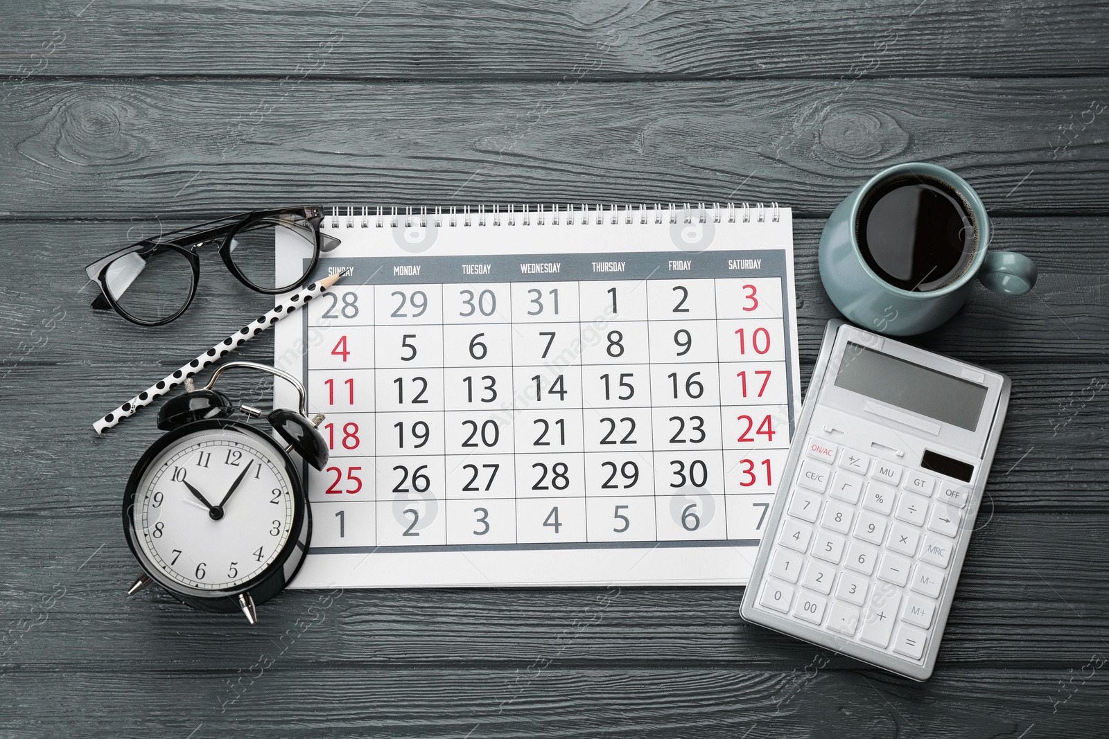 Photo of Flat lay composition with calendar and cup of coffee on grey wooden table