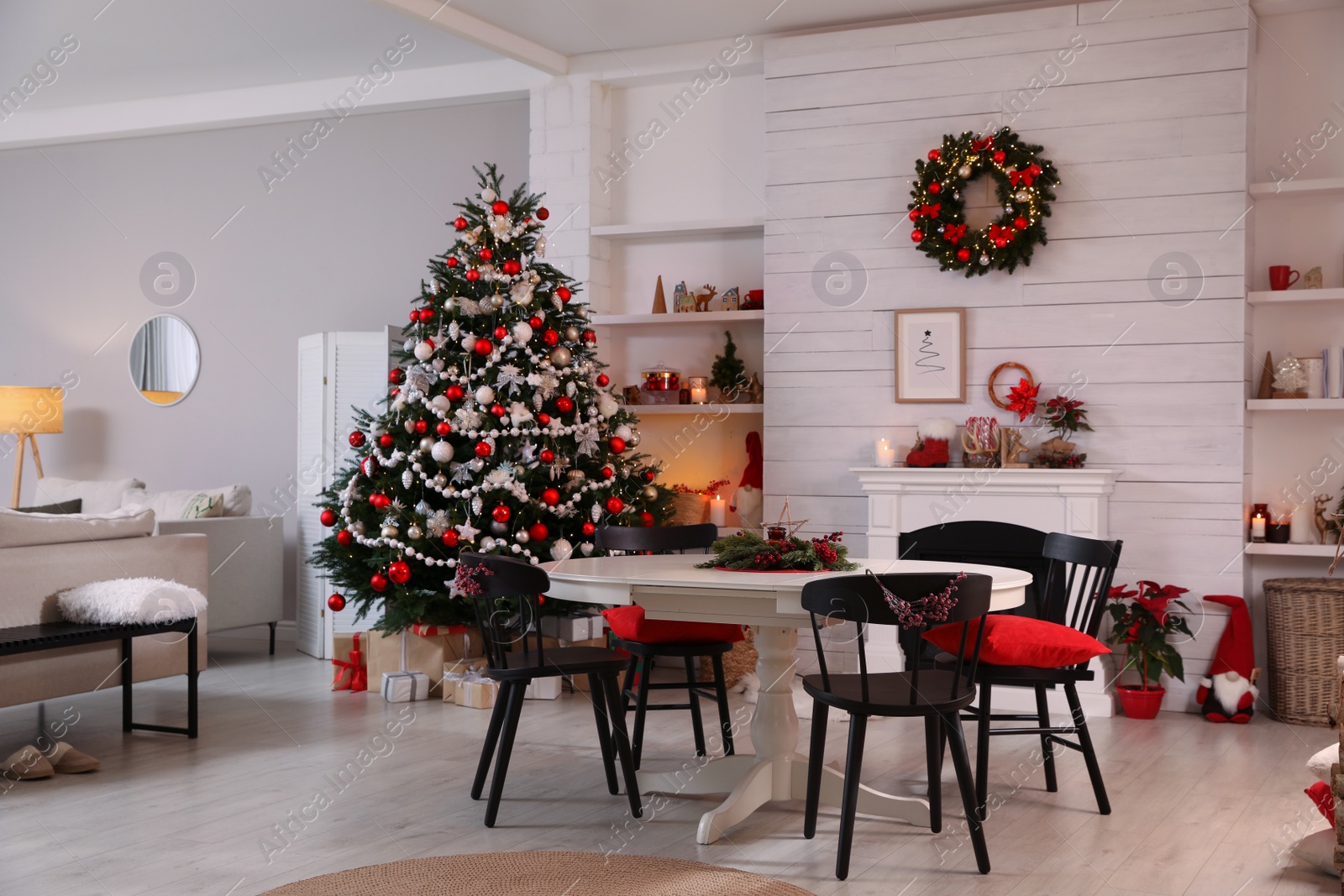 Photo of Cozy dining room interior with Christmas tree and festive decor