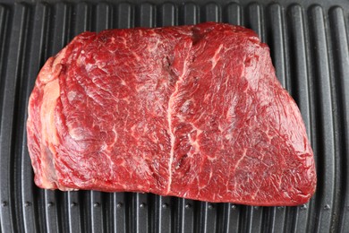 Photo of Cooking fresh beef cut on electric grill, top view