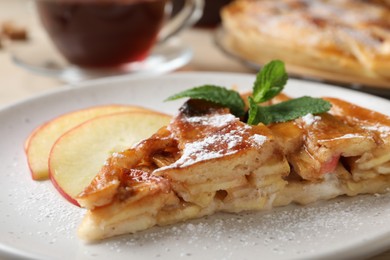 Slice of traditional apple pie on plate, closeup