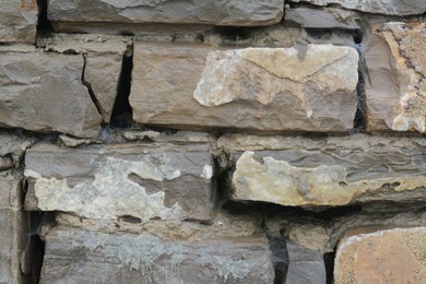 Wall with different stone fragments as background, closeup