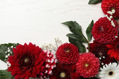 Photo of Flat lay composition with beautiful dahlia flowers on white wooden background. Space for text