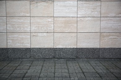 Photo of View on urban tiled wall and pavement