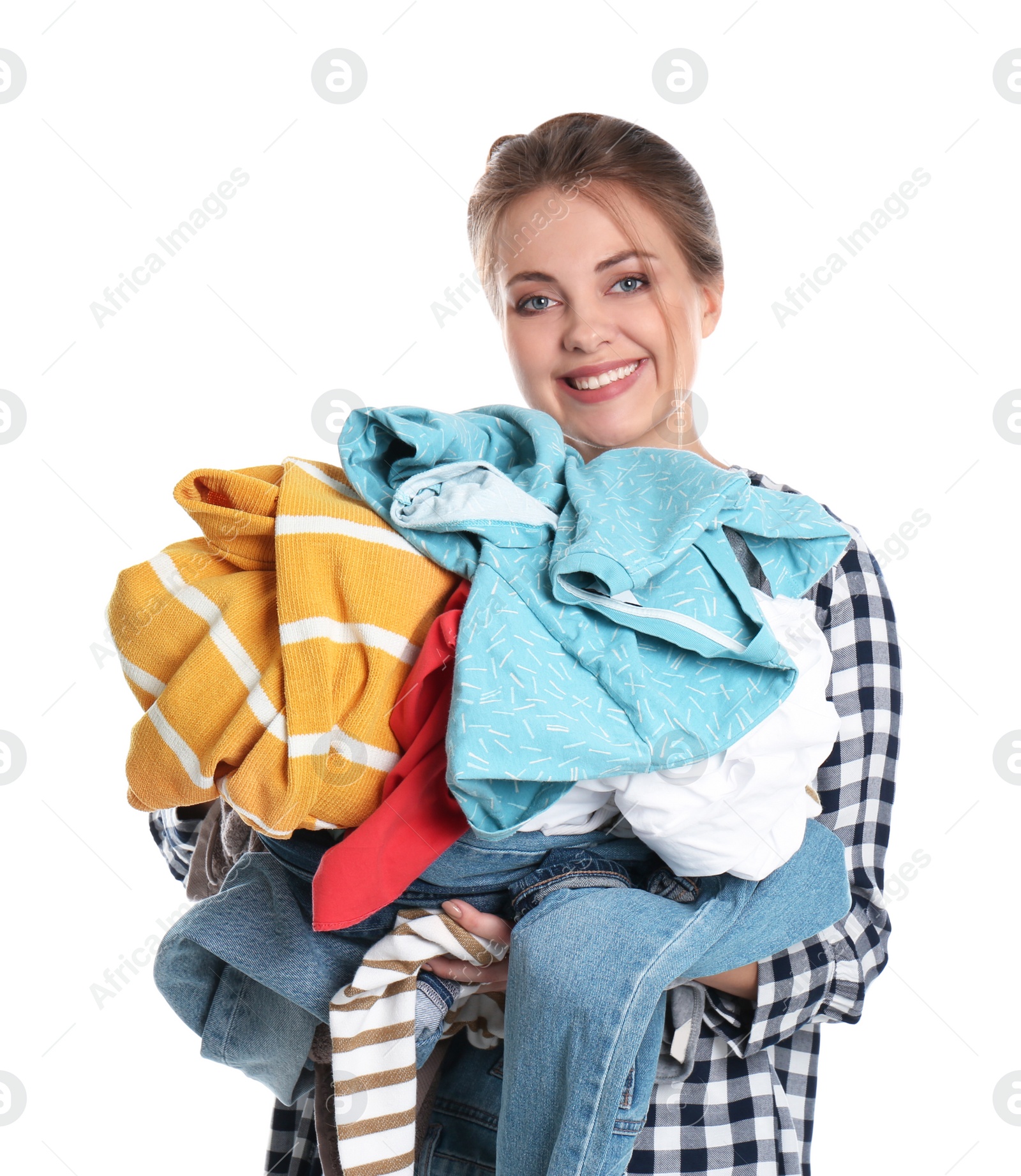 Photo of Happy young woman holding pile of dirty laundry on white background