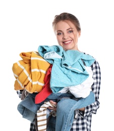 Photo of Happy young woman holding pile of dirty laundry on white background