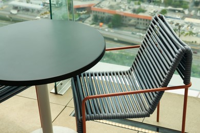 Coffee table and chair against picturesque landscape of city in cafe