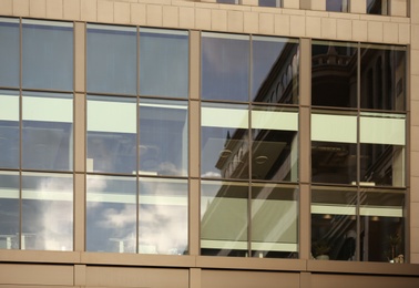 Photo of Modern office building with large windows. Urban architecture