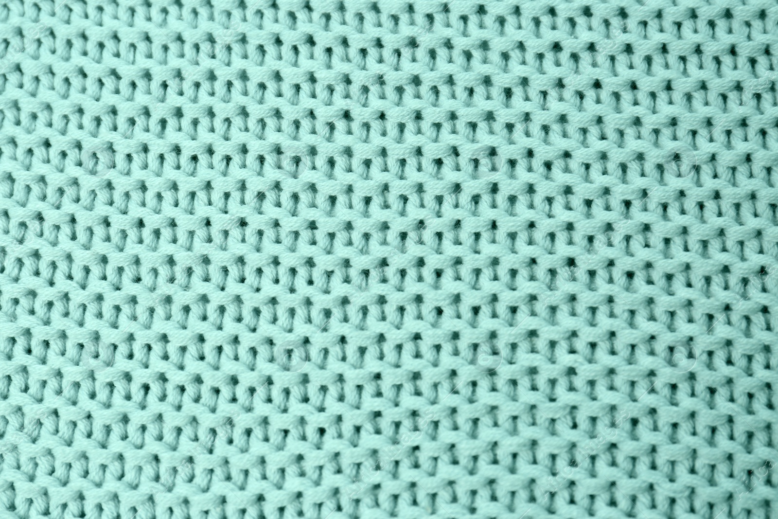 Photo of Knitted mint blue fabric as background, top view