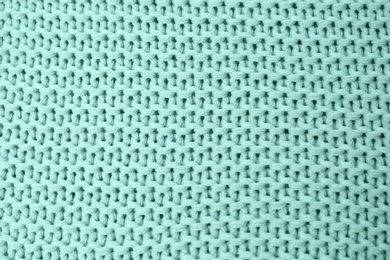 Knitted mint blue fabric as background, top view