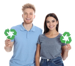 Young couple with recycling symbols on white background