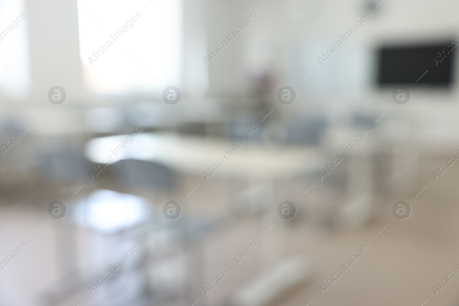 Photo of Blurred view of empty school classroom with desks and chairs