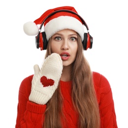 Photo of Young woman in Santa hat listening to Christmas music on white background