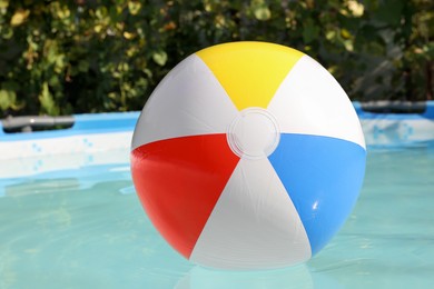 Photo of Inflatable ball on water in above ground swimming pool outdoors, closeup