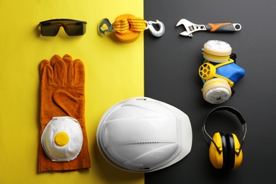 Photo of Flat lay composition with safety equipment and space for text on color background