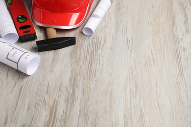 Photo of Building level and other construction tools on white wooden table, space for text