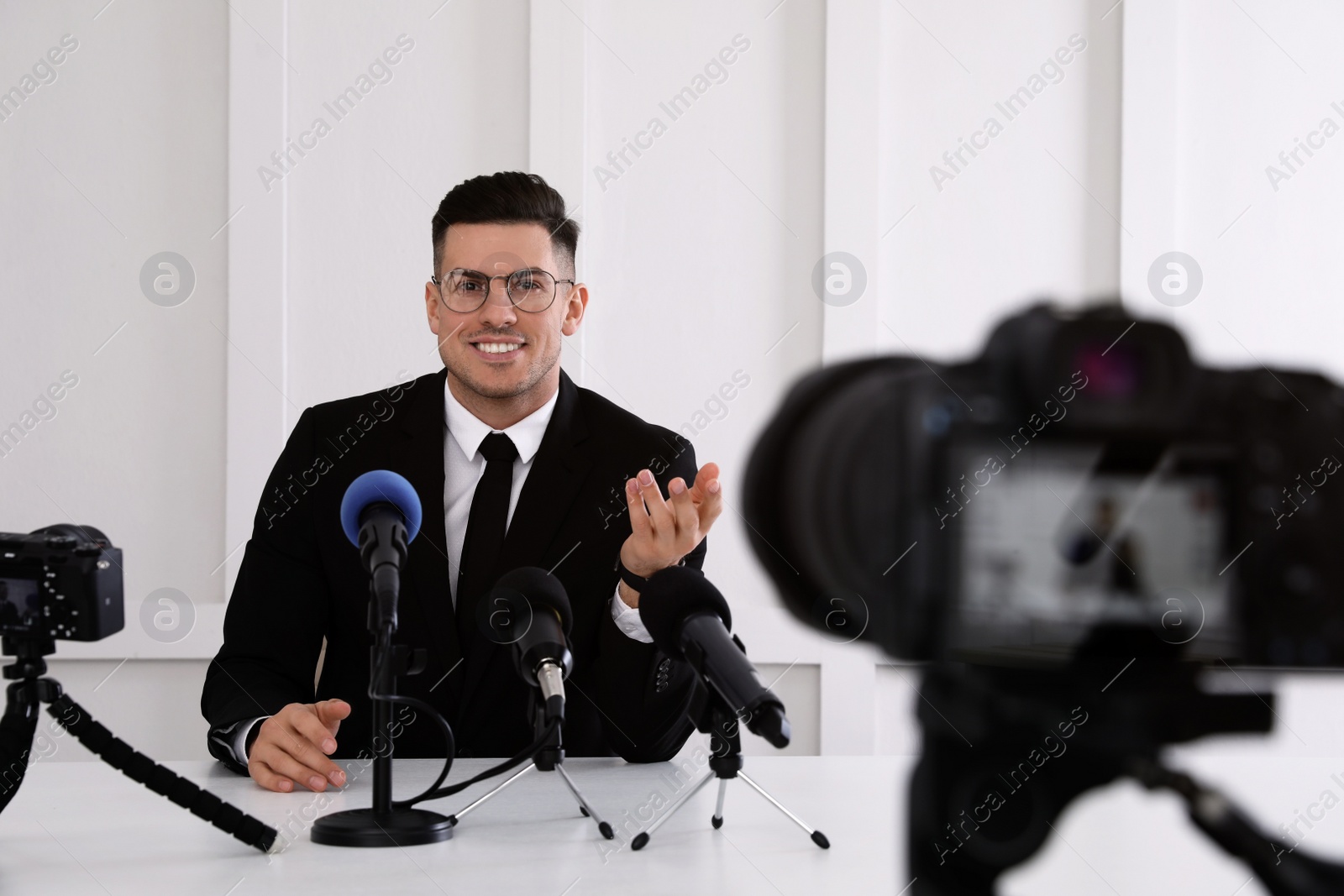 Photo of Business man giving interview at official event