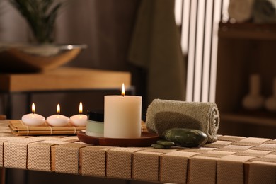 Beautiful composition with different spa products on wicker bench indoors