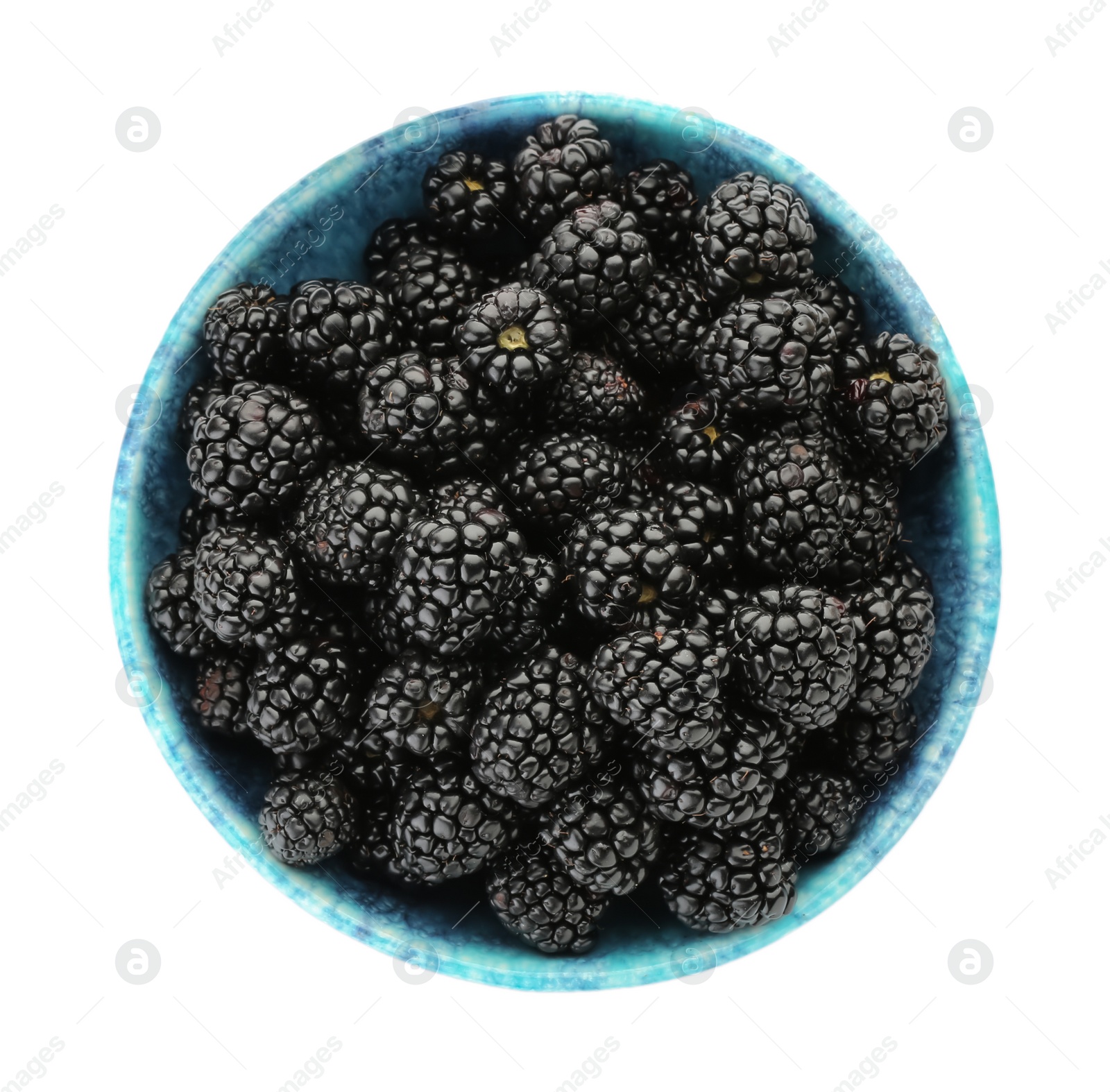 Photo of Tasty ripe blackberries in bowl isolated on white, top view