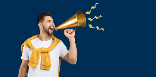 Image of Young man with megaphone on blue background