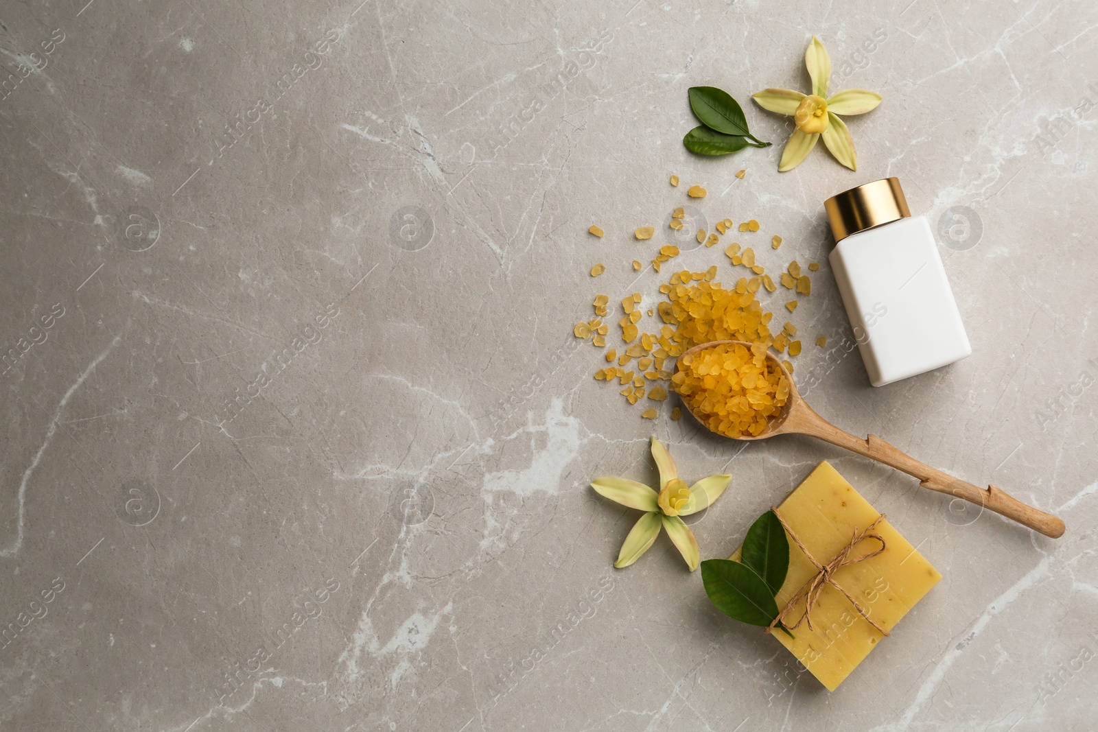 Photo of Flat lay composition with spa supplies on stone table. Space for text