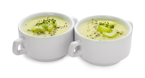 Bowls of delicious celery soup on white background