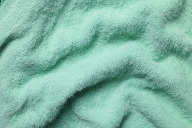 Photo of Texture of soft turquoise fabric as background, top view