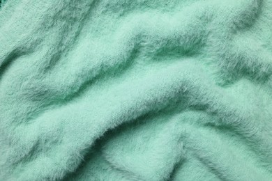 Texture of soft turquoise fabric as background, top view