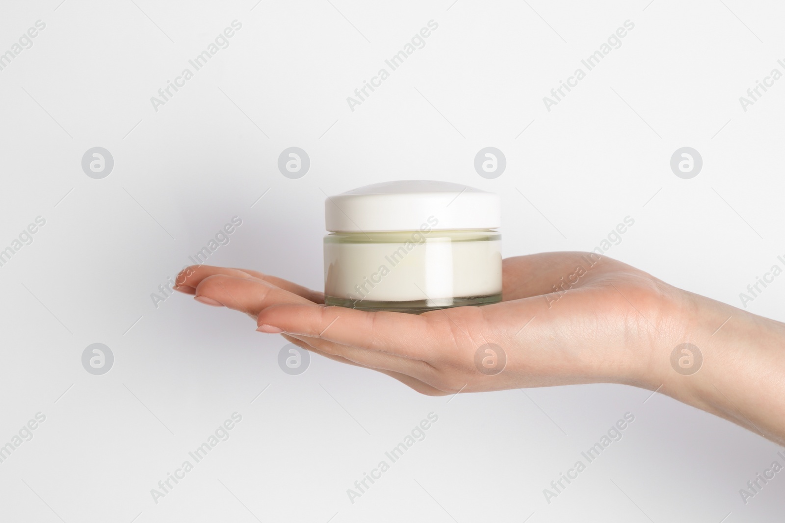 Photo of Woman with jar of cream on white background, closeup