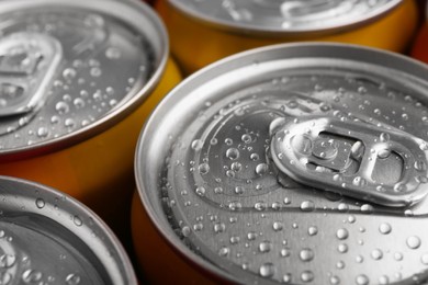 Photo of Energy drinks in wet cans, closeup. Functional beverage