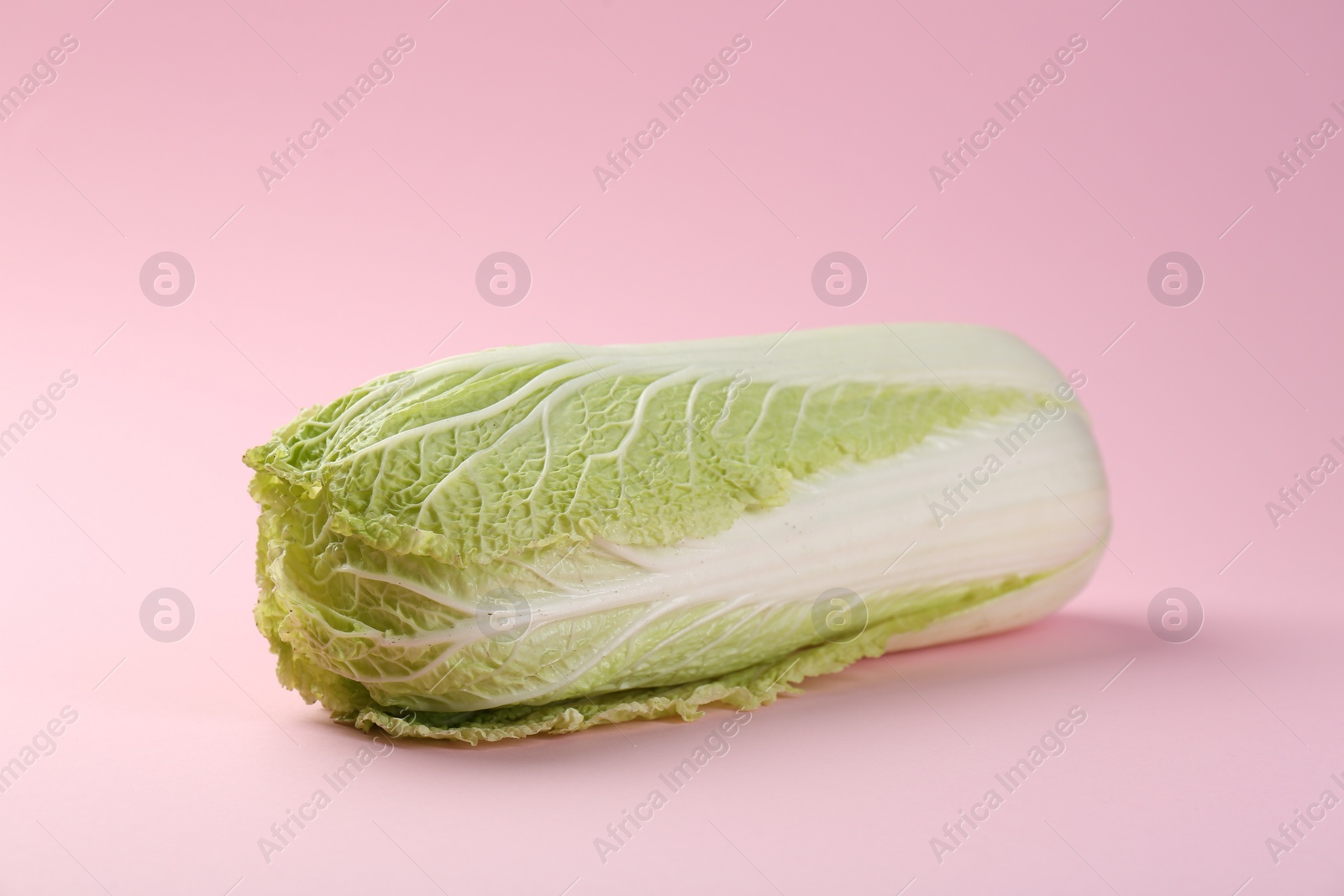 Photo of Fresh ripe Chinese cabbage on pink background