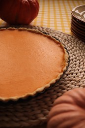 Photo of Delicious homemade pumpkin pie in baking dish on table