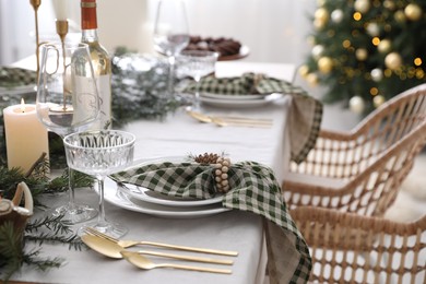 Christmas table setting with festive decor and dishware indoors