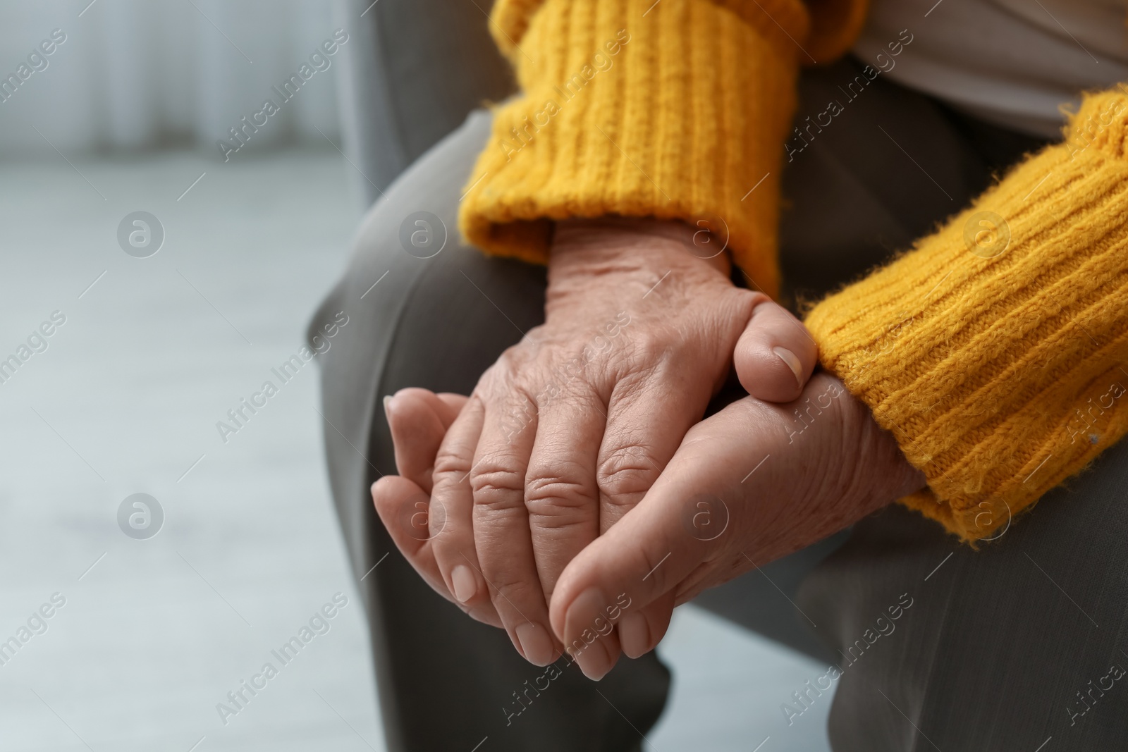 Photo of Elderly woman indoors, closeup. Space for text