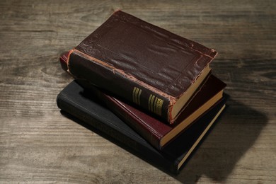 Stack of old hardcover books on wooden table