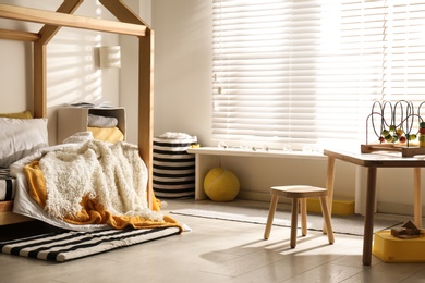 Cozy child room interior with comfortable bed