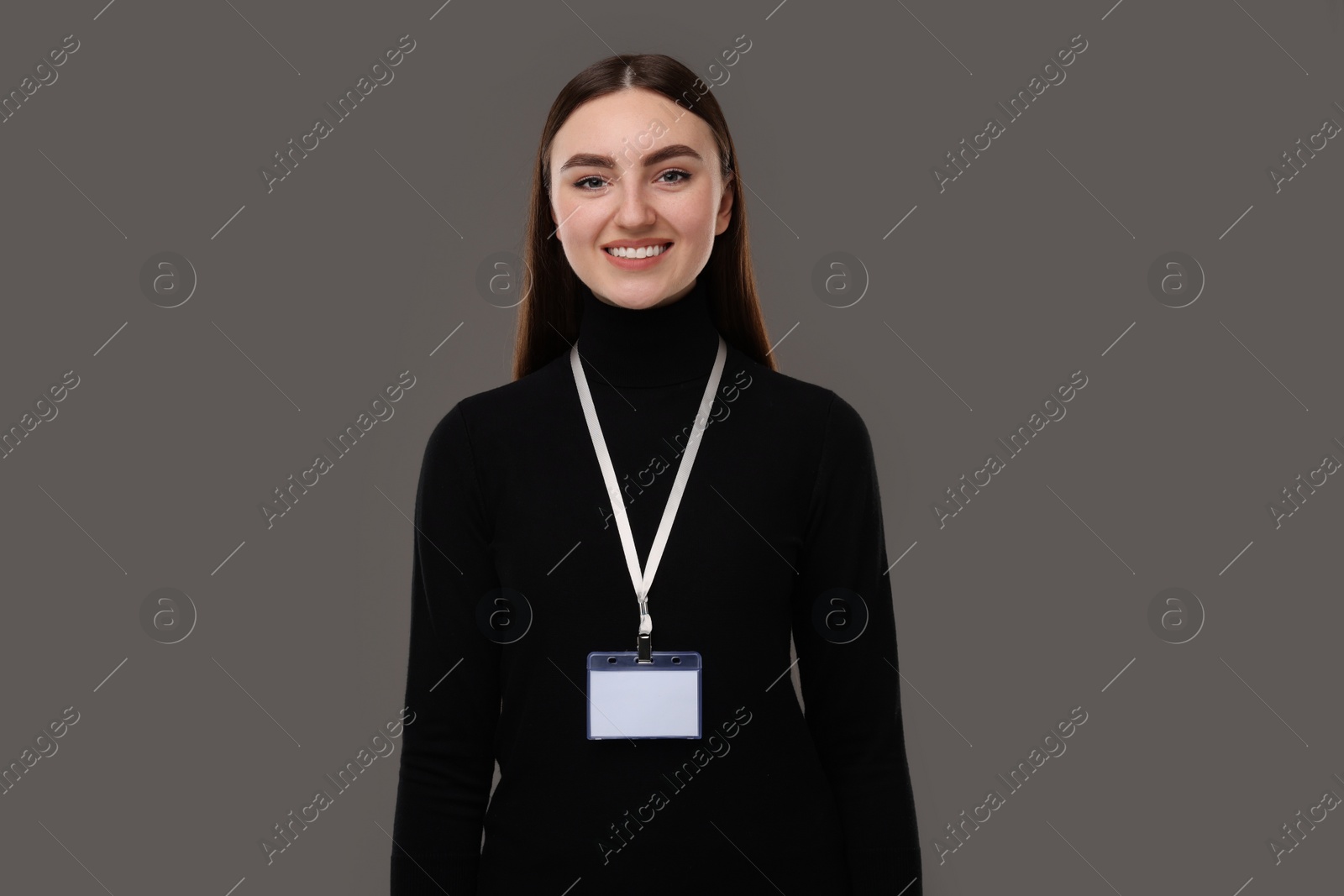 Photo of Happy woman with blank badge on grey background