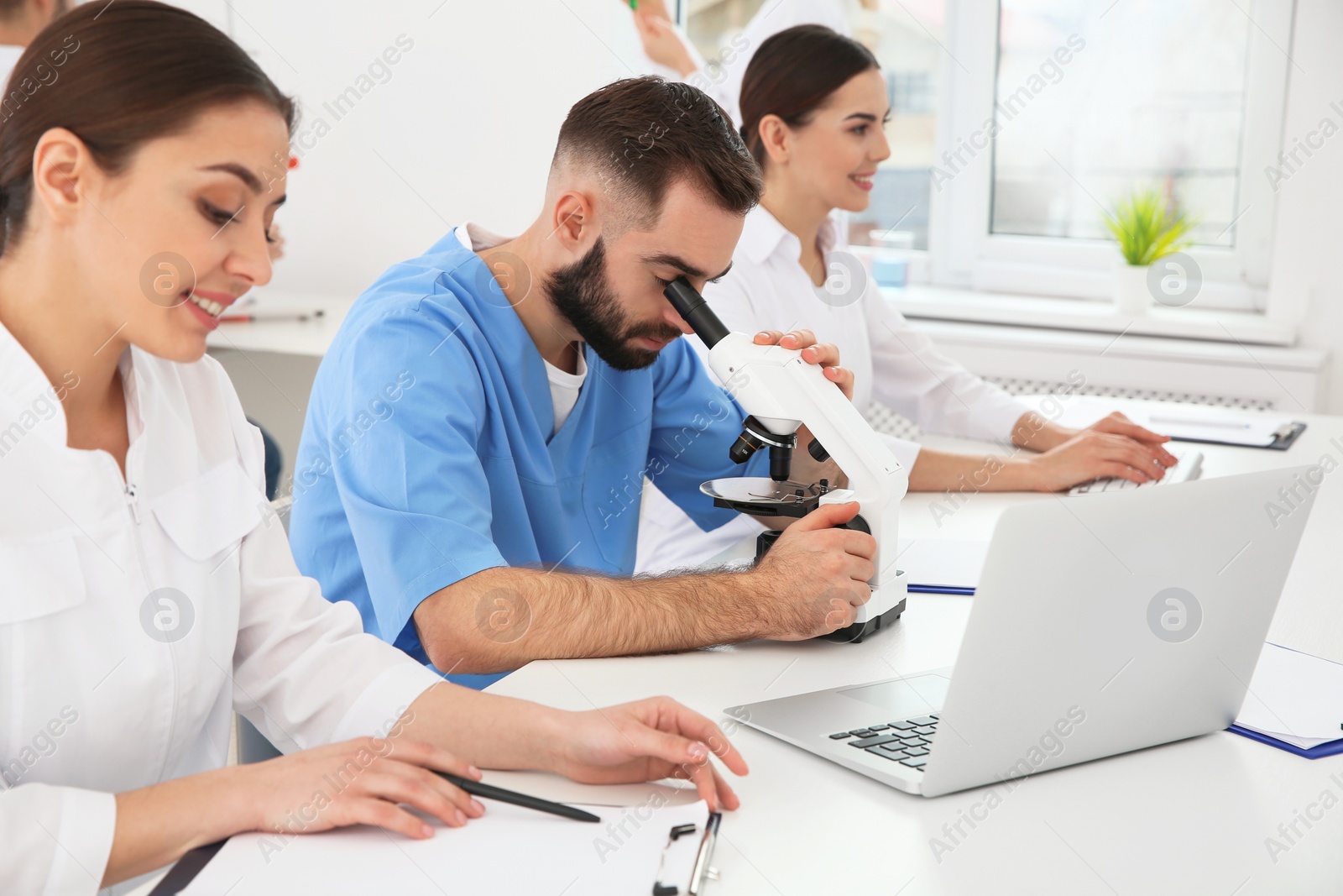 Photo of Medical students working in modern scientific laboratory