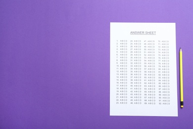 Photo of Answer sheet and pencil on color background, top view with space for text