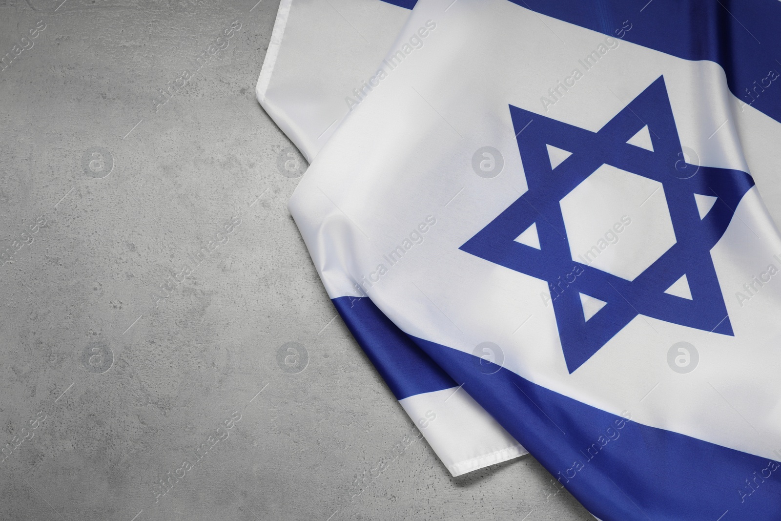 Photo of Flag of Israel on grey background, top view and space for text. National symbol