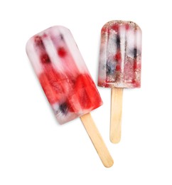 Photo of Tasty berry popsicles on white background, top view